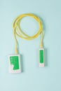 Lan tester and yellow cable on blue background. Royalty Free Stock Photo