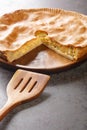 Lancashire cheese and onion shortcrust pie is a hearty English dish closeup in the olate on the table. Vertical