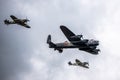 Lancaster bomber with a hurricane and spitfire flying beside it from below