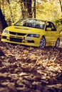 Lancer Evo 9 in the autumn road Royalty Free Stock Photo