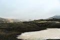 Land covered in green fresh moss and melting snow seen while trekking in Iceland Royalty Free Stock Photo