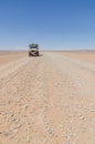 Land Cruiser 4x4 on empty rocky desert road to Erg Chebbi in the Moroccan Sahara, Africa