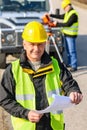 Land geodesist man hold plan reflective vest Royalty Free Stock Photo