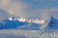 Land of ice. Travelling in Arctic Norway. White snowy mountain, blue glacier Svalbard, Norway. Ice in ocean. Iceberg in North pole Royalty Free Stock Photo