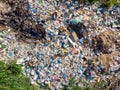 Land pollution with plastic bottles and bags. Open storage of solid waste garbage. Aerial top view Royalty Free Stock Photo