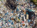 Land pollution with plastic bottles and bags. Open storage of solid waste garbage. Aerial top view Royalty Free Stock Photo