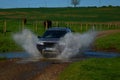 Land Rover freelander in ford water Royalty Free Stock Photo