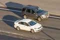 Land Rover Range Rover ahead of Volkswagen white rides highway. Russia. Saint-Petersburg. 06 july 2018.