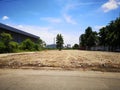 Land for sale concept. Landscape of empty land plot for development, and beautiful blue sky. Royalty Free Stock Photo