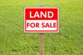 Land For Sale - Real estate concept with a vacant lot for sale available for building construction Royalty Free Stock Photo