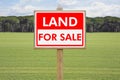 Land For Sale - Real estate concept with a vacant lot for sale available for building construction Royalty Free Stock Photo