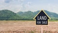 Land for sale sign against trimmed lawn background. Empty dry cracked swamp reclamation soil, land plot for housing Royalty Free Stock Photo