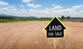 Land for sale sign against trimmed lawn background. Empty dry cracked swamp reclamation soil, land plot for housing construction Royalty Free Stock Photo