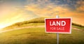 land for sale sign against trimmed lawn background. Empty dry cracked swamp reclamation soil, land plot for housing construction Royalty Free Stock Photo