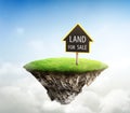 Land for sale sign on cubicle soil and geology cross section with green grass. fantasy floating island natural landscape with Royalty Free Stock Photo