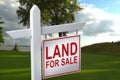 LAND FOR SALE SIGN on empty meadow - Real estate conceptual image. Royalty Free Stock Photo