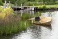 Landcape with abandoned fishing boat in harbor.