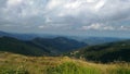 Landcapes on the mountain with cloudy sky and field.