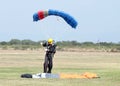 Landed skydiver looks as though he has extra small chute other