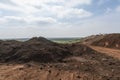 landfill being covered with topsoil and seeded to enable natural regeneration Royalty Free Stock Photo