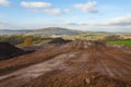 landfill being covered with topsoil and seeded to enable natural regeneration Royalty Free Stock Photo