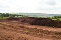 landfill being covered with topsoil and seeded to enable natural regeneration