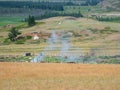 Landfill garbage fire inferno in mountain steppe with heavy smoke