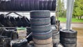 Landfill with old tires and tires for recycling. Disposal of used tires. Worn wheels for recycling. Royalty Free Stock Photo