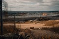 landfill surrounded by a fence and security patrol for safety