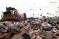 Landfill truck in trash