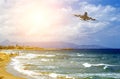 Landing aircraft takes off above tropical beach. Sea, shore and sky landscape. Travel destinations concept Royalty Free Stock Photo