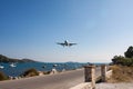 Landing of an airliner on the airport runway in the summer, passing over the marina Royalty Free Stock Photo