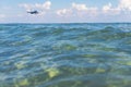 Landing airplane above transparent sea water