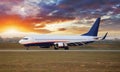 Landing airplane in Airport at sunset