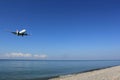Landing airplane over the sea and beach