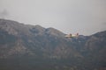 Landing airplane to the airfield of Tivat, flying over mountain in Montenegro.