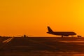 Landing airplanes against colorful sky at sunset. Travel background with passenger plane. Evacuation Royalty Free Stock Photo