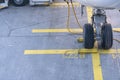 Landing Gear of a modern airliner - tires of a plane - close up shot. Wheels of airplane with aircraft chocks on the la