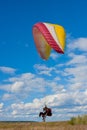 Landing of paraglider on a background sky