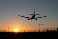 Landing passenger plane during sunset Royalty Free Stock Photo