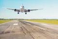 Landing plane on the runway in strong winds at the airport Royalty Free Stock Photo