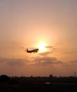 Landing plane on a sunset Royalty Free Stock Photo