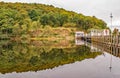 The landing stage in beautiful symetrical reflection on the lake