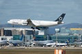 Landing Star Alliance Airbus A340 airplane in front of an airport terminal Royalty Free Stock Photo