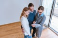 Landlady or realtor showing lease agreement to new tenants Royalty Free Stock Photo