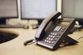 Landline phone on office desk with computer monitors and keyboards Royalty Free Stock Photo