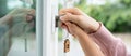 Landlord key for unlocking house is plugged into the door. Second hand house for rent and sale. Owner use hand unlock door Royalty Free Stock Photo