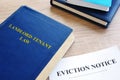 Landlord-Tenant Law and eviction notice on a desk. Royalty Free Stock Photo