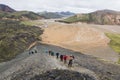 LANDMANNALAUGAR, ICELAND - AUGUST 2018: Tourists trekking in the colourful mountains of Landmannalaugar national park