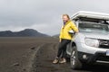 LANDMANNALAUGAR, ICELAND - AUGUST 2018: woman standing next to an offroad car in Landmannalaugar area, Iceland